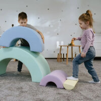 Junge spielt mit bunten Schaumstoffelementen in einem Spielzimmer