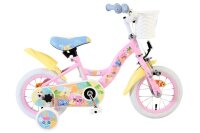 Rosa Kinderfahrrad mit bunten Aufklebern und Korb vorne