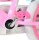 Pinkes Kinderfahrrad mit Pedal und weißem Reifen im Hintergrund