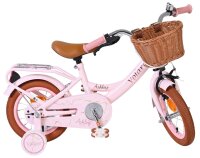 Rosa Kinderfahrrad mit Korb und braunen Reifen