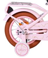 Rosa Fahrrad mit braunem Reifen und reflektierendem Rücklicht