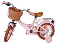 Rosa Kinderfahrrad mit Korb, braunen Reifen und gepolstertem Sattel