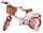 Rosa Kinderfahrrad mit Korb, braunen Reifen und gepolstertem Sattel