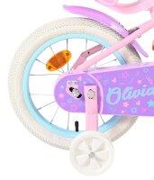 Rosa Kinderfahrrad mit weißen Reifen und bunten...