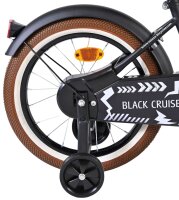 Schwarzes Fahrrad mit braunem Reifen und reflektierendem...