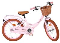 Rosa Damenfahrrad mit Korb und braunen Reifen