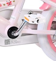 Rosa Kinderfahrrad mit weißen Pedalen und bunten Verzierungen