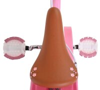 Rosa Kinderfahrrad mit braunem Sattel und blütenförmigen Griffen