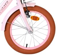 Vorderreifen eines Fahrrads mit pinkem Rahmen und braunem Reifen
