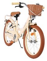 Beige Kinderfahrrad mit Korb und braunen Reifen